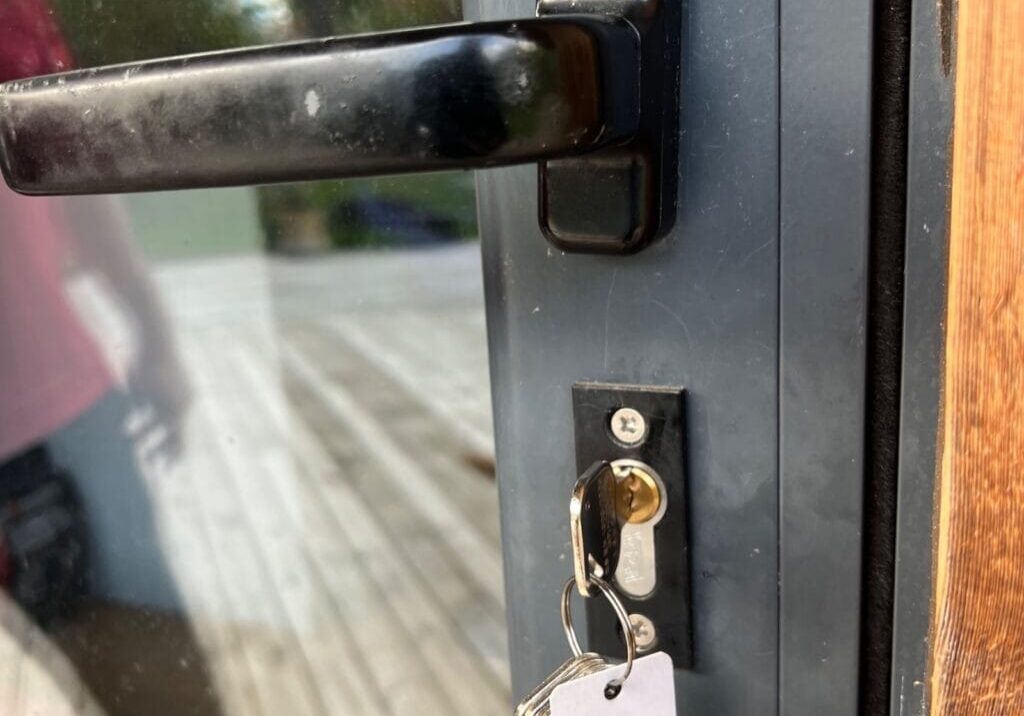 Close-up of new euro lock cylinder with keys inserted on a garden bar door in Black Notley