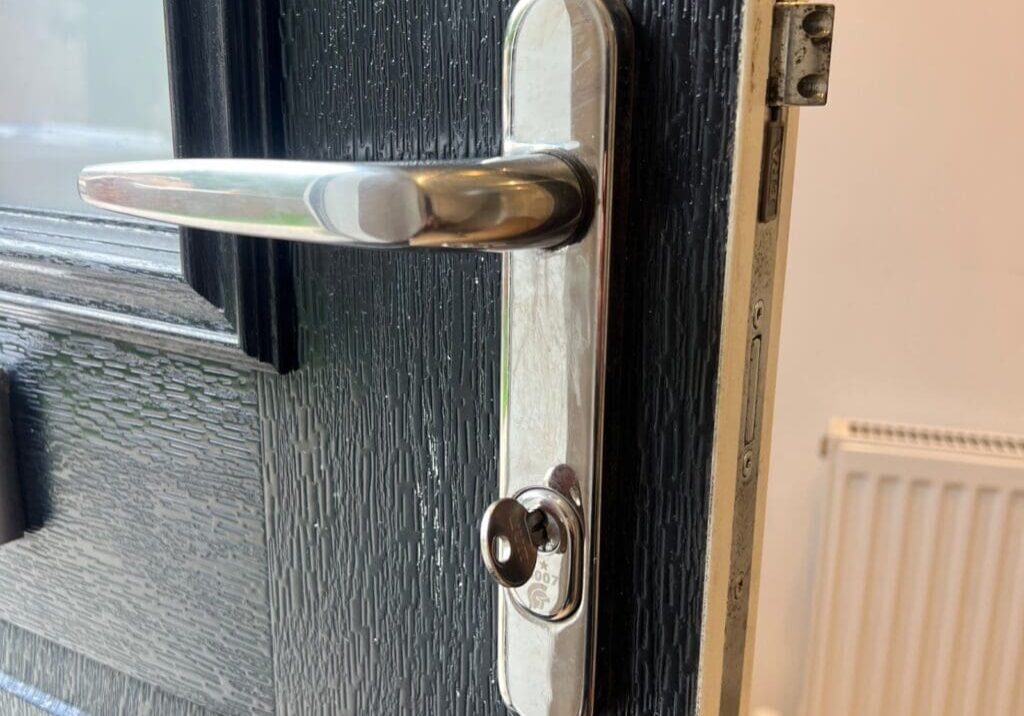 Close-up of a composite door handle with a key inserted in the euro thumbturn lock in Coggeshall